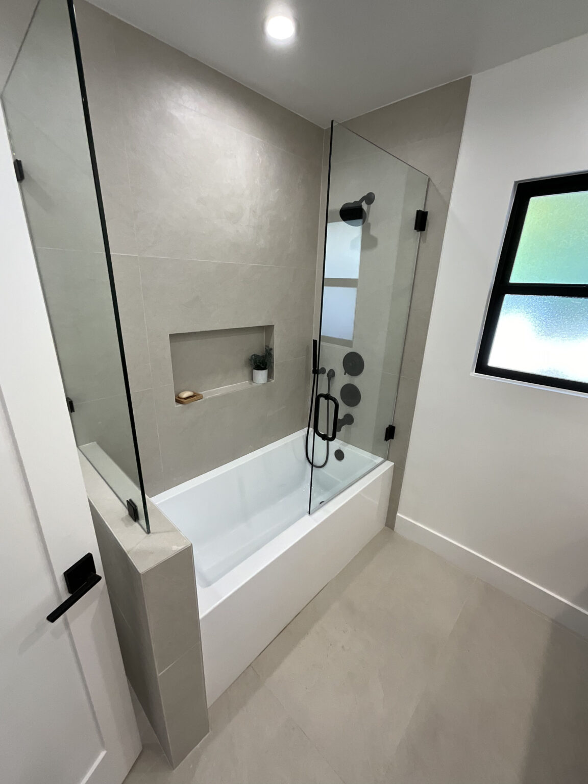 Remodeled tub and shower with tiled niche