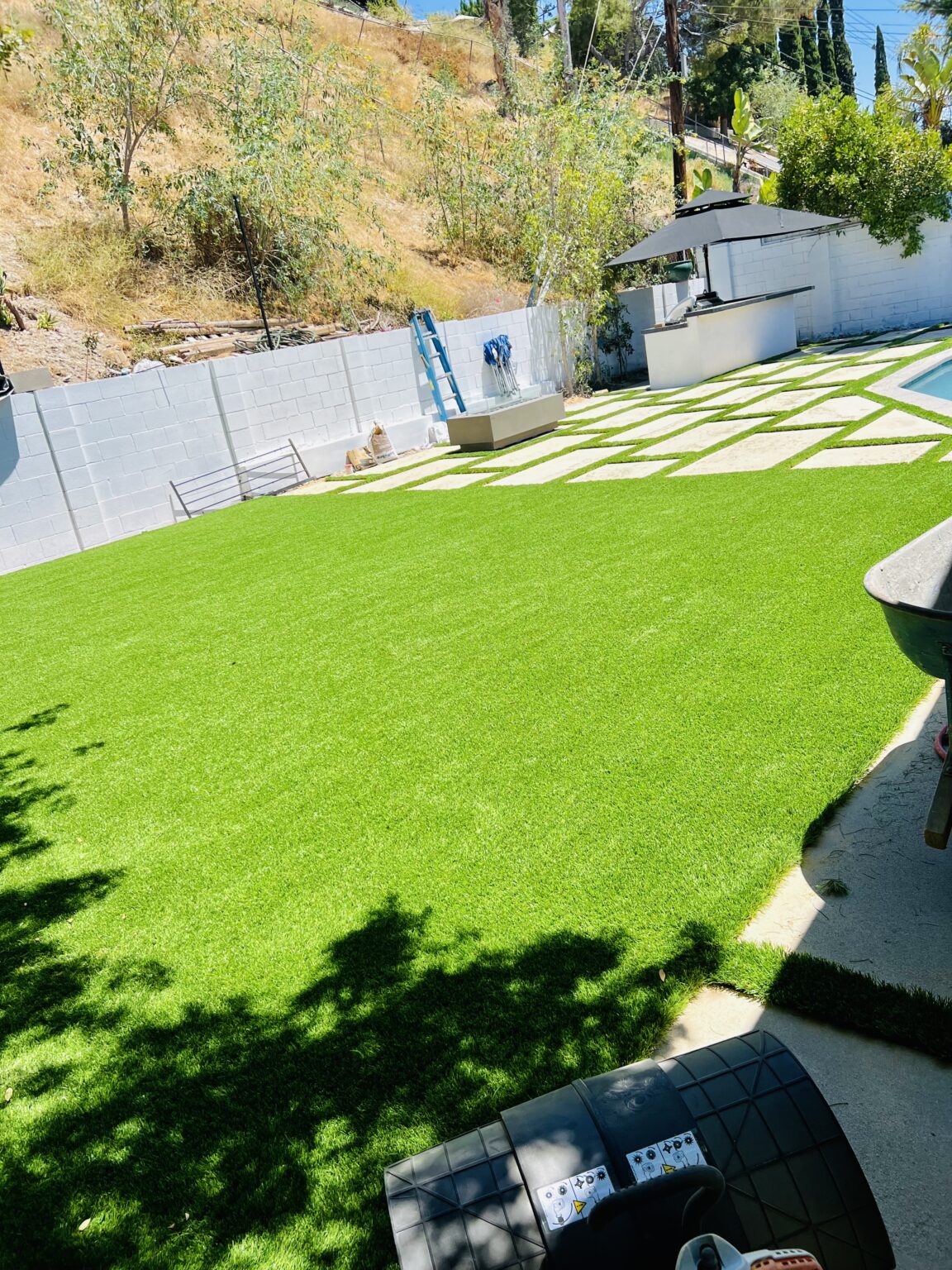 Backyard with turf and paver walkway